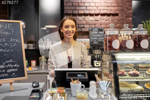 Image of happy woman or barmaid with cashbox at cafe