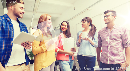 Image of creative team on coffee break talking at office