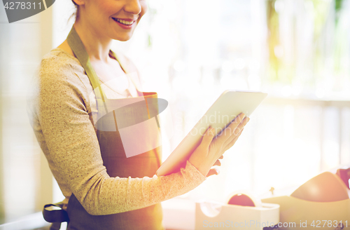 Image of close up of woman with tablet pc at flower shop