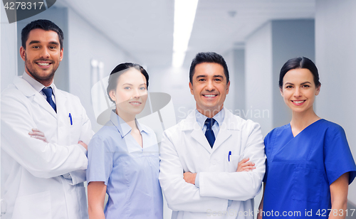 Image of happy group of medics or doctors at hospital