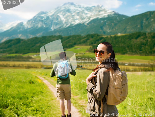 Image of happy couple with backpacks traveling in highlands