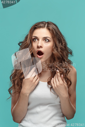 Image of Portrait of young woman with shocked facial expression