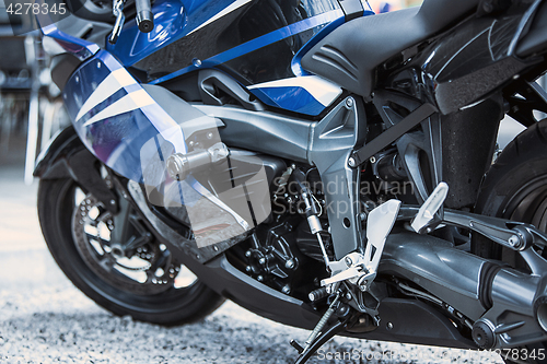 Image of Motorcycle luxury items close-up: headlights, shock absorber, wheel, wing, toning.