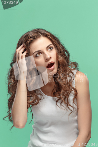 Image of Portrait of young woman with shocked facial expression