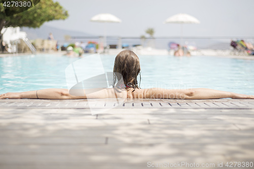 Image of Woman relaxing in swimming pool