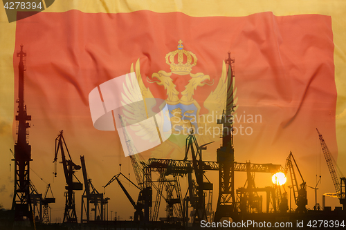 Image of Industrial concept with Montenegro flag at sunset