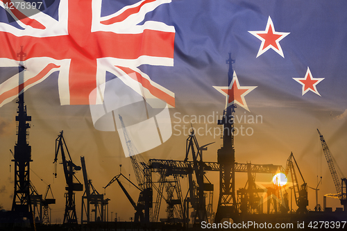 Image of Industrial concept with New Zealand flag at sunset