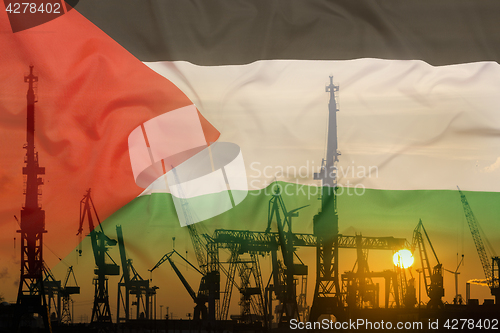 Image of Industrial concept with Palestine flag at sunset