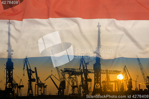 Image of Industrial concept with Netherlands flag at sunset