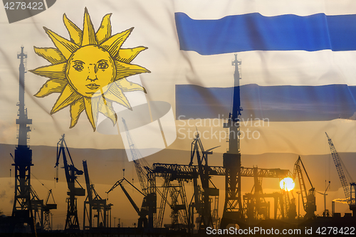 Image of Industrial concept with Uruguay flag at sunset