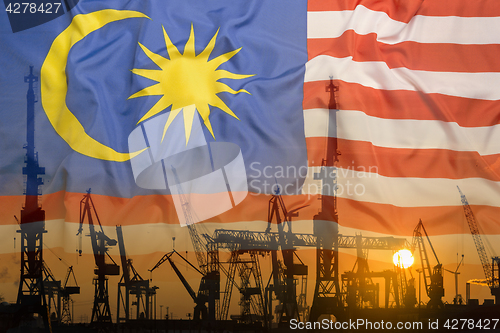 Image of Industrial concept with Malaysia flag at sunset