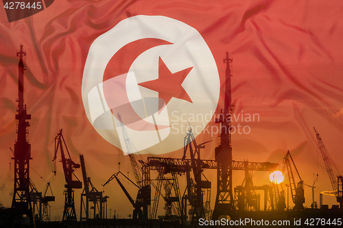 Image of Industrial concept with Tunisia flag at sunset