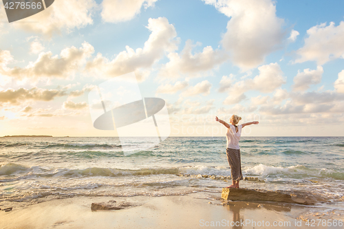 Image of Free Happy Woman Enjoying Sunset on Sandy Beach