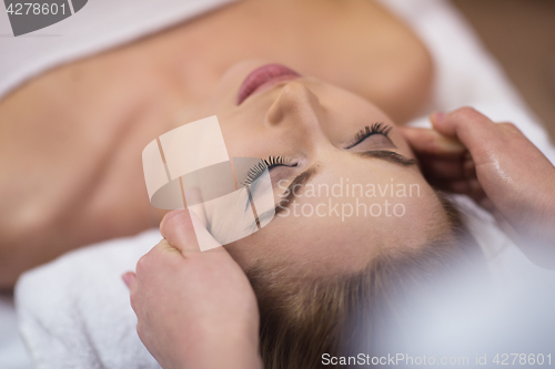 Image of woman receiving a head massage