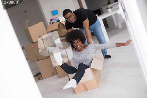 Image of African American couple  playing with packing material