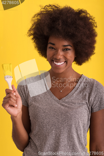 Image of black woman painting wall