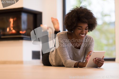 Image of black women using tablet computer on the floor