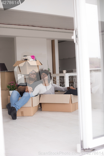 Image of African American couple  playing with packing material