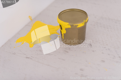 Image of Yellow paint tin can