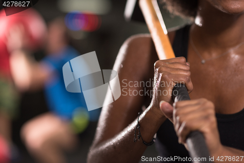 Image of black woman after workout with hammer