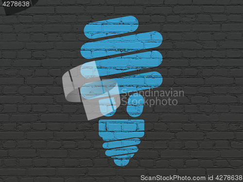 Image of Business concept: Energy Saving Lamp on wall background