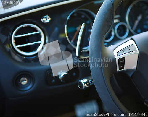 Image of Control buttons on the steering wheel of a car