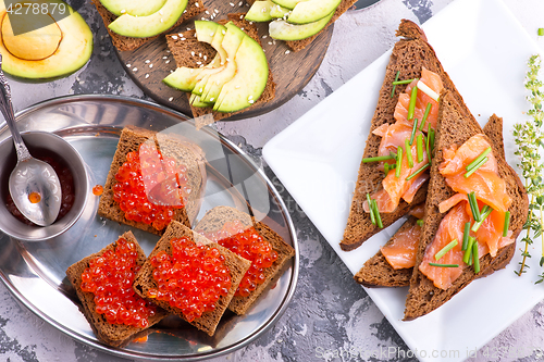 Image of bread with red salmon caviar 