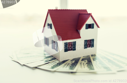 Image of close up of home or house model and money