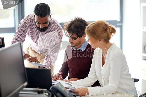 Image of business team with tablet pc in office