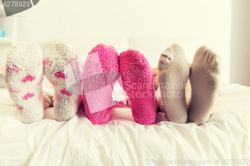 Image of close up of women feet in socks on bed at home