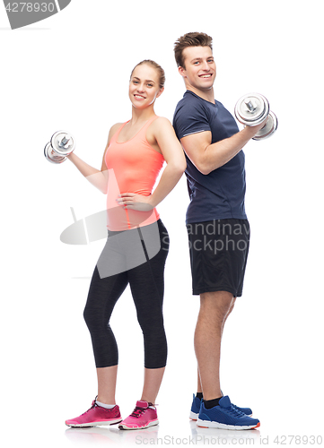 Image of sportive man and woman with dumbbells
