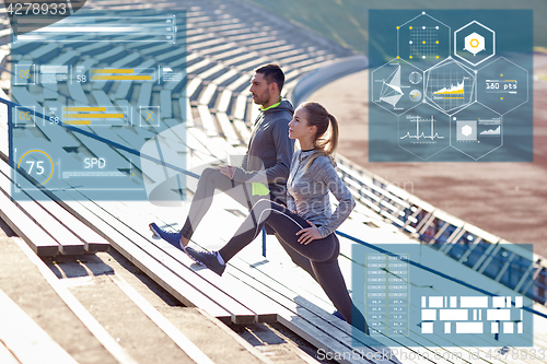 Image of sporty couple stretching leg on stands of stadium