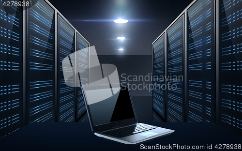 Image of laptop computer over server room background