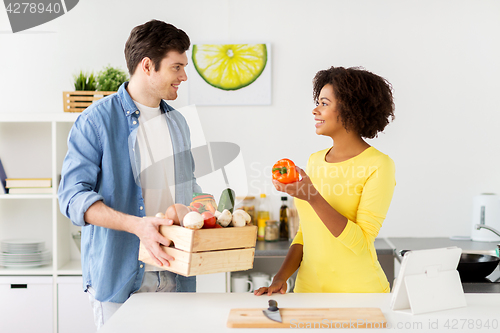 Image of happy couple with healthy food at home kitchen