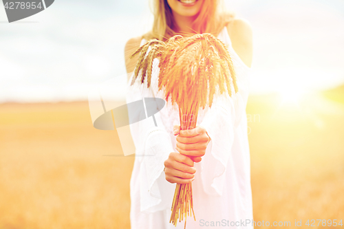 Image of close up of happy woman with cereal spikelets