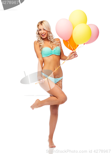 Image of happy woman in bikini swimsuit with air balloons
