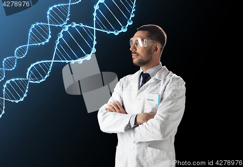 Image of scientist in lab coat and safety glasses with dna