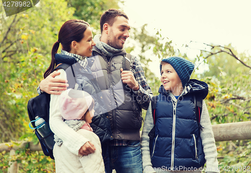 Image of happy family with backpacks hiking