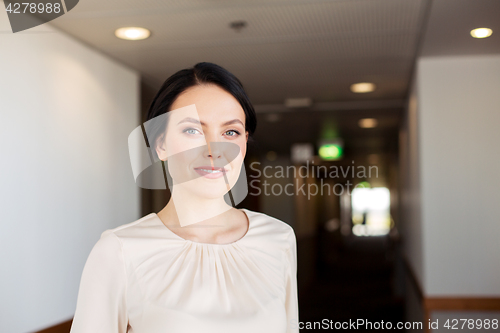 Image of happy woman at corridor in hotel