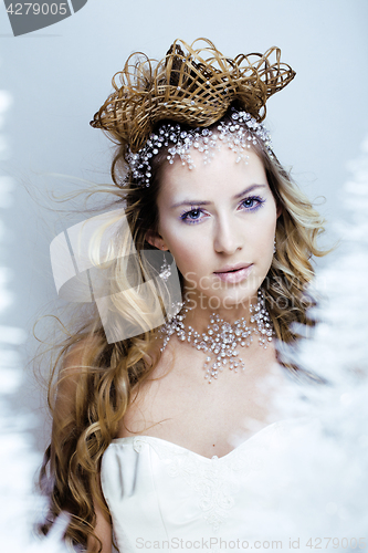 Image of beauty young snow queen with hair crown on her head, complicate 