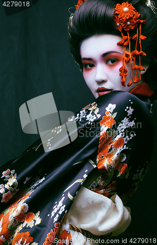 Image of young pretty geisha in kimono