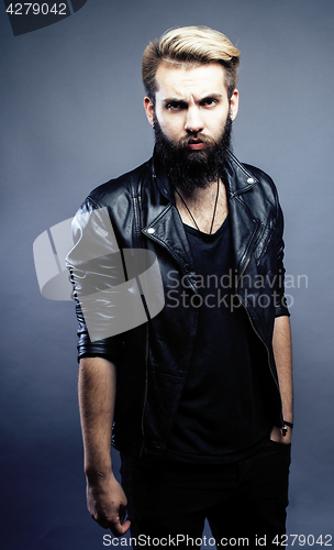 Image of portrait of young bearded hipster guy smiling on gray dark background close up, brutal modern man, lifestyle people concept 