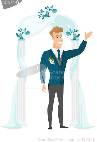 Image of Happy groom standing under the wedding arch.
