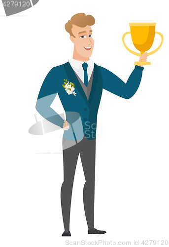 Image of Caucasian groom holding a trophy.