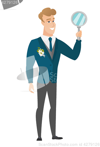 Image of Caucasian groom holding hand mirror.