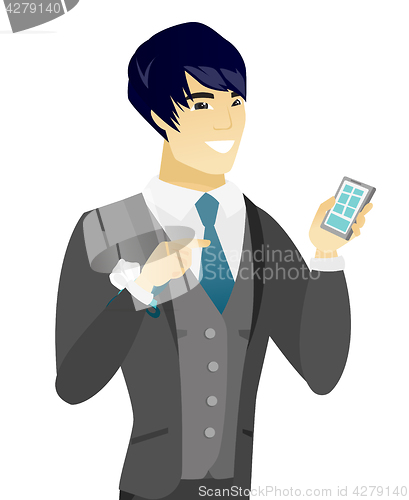 Image of Young asian groom holding a mobile phone.