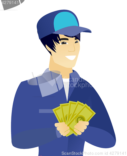 Image of Young asian mechanic holding money.