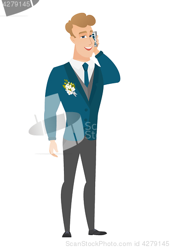 Image of Groom talking on a mobile phone.