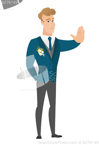 Image of Caucasian groom showing stop hand gesture.