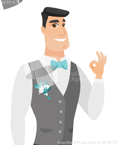 Image of Young caucasian groom showing ok sign.